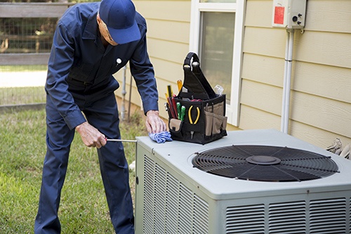 Tech checking AC Unit